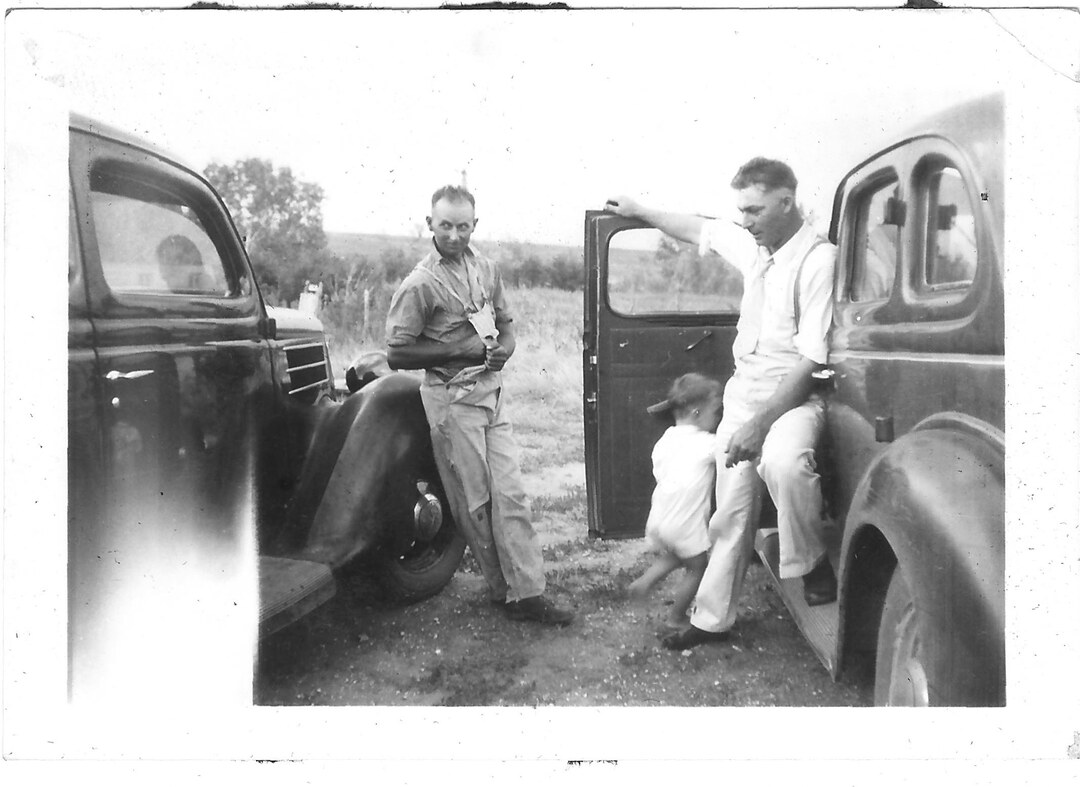 Photograph (106)
1935, probably Hunter, KS.  Frank Lee, Leslie VanAmburg with Eugene.
