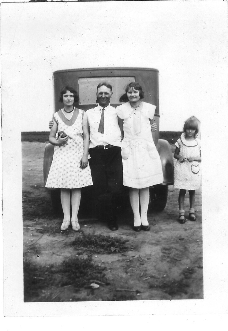 Photograph (146)
1930, Kansas.  Uncle Ben McNall with Irene, Margaret, and Marie.  Irene is holding the box camera that ook so many of these early pictures.
